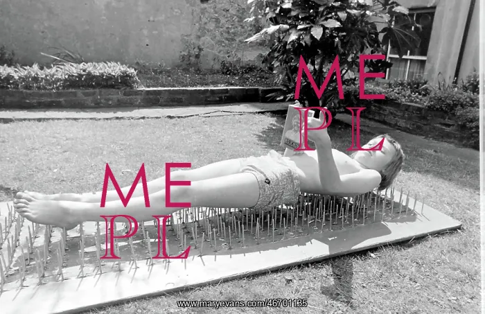 : Boy stuntman on bed of nails : Boy stuntman on bed of nails