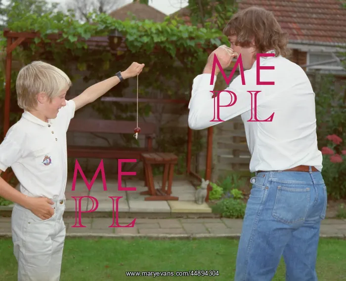 : Boy and young man playing conkers in the garden : Boy and young man playing conkers in the garden