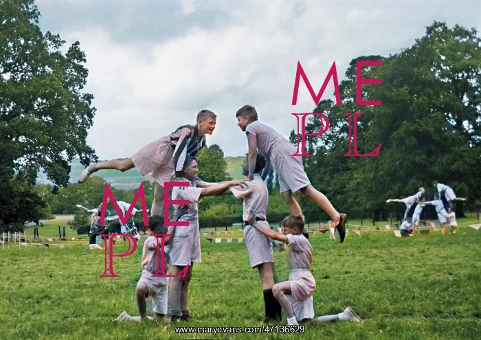  : Boys doing acrobatics in a field