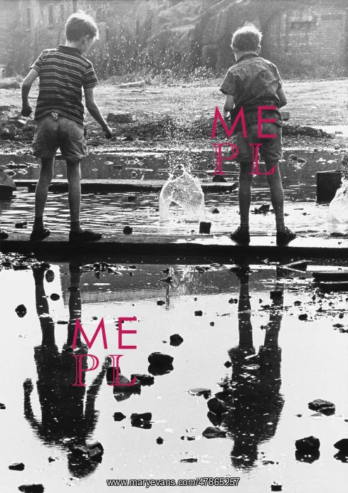  : Two boys drop bricks into a puddle