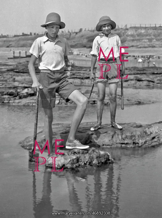 : Two boys exploring rock pools at the seaside : Two boys exploring rock pools at the seaside