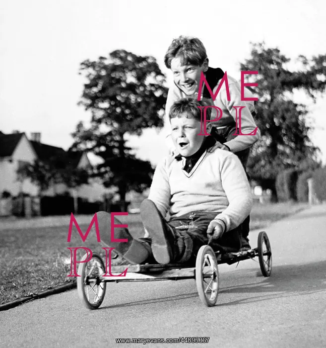 : Two boys on a home-made go-kart : Two boys on a home-made go-kart