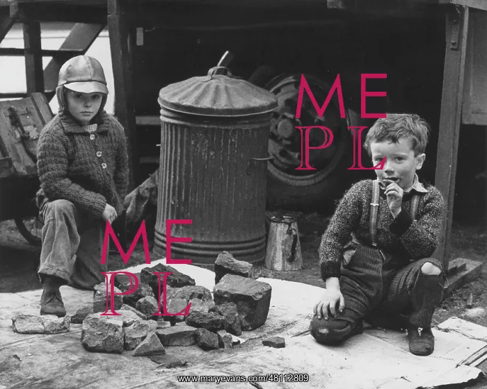 : Two boys with pile of rocks : Two boys with pile of rocks