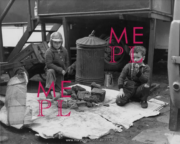 : Two boys with pile of rocks : Two boys with pile of rocks