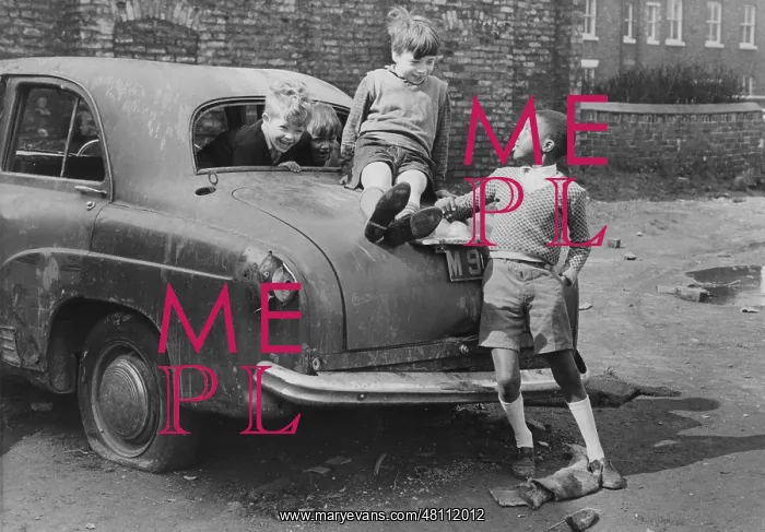 : Three boys playing on an abandoned car : Three boys playing on an abandoned car