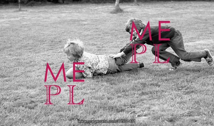  : Two boys playing on the grass