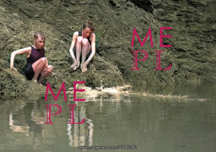 : Two boys in swimsuits sitting on a rock : Two boys in swimsuits sitting on a rock