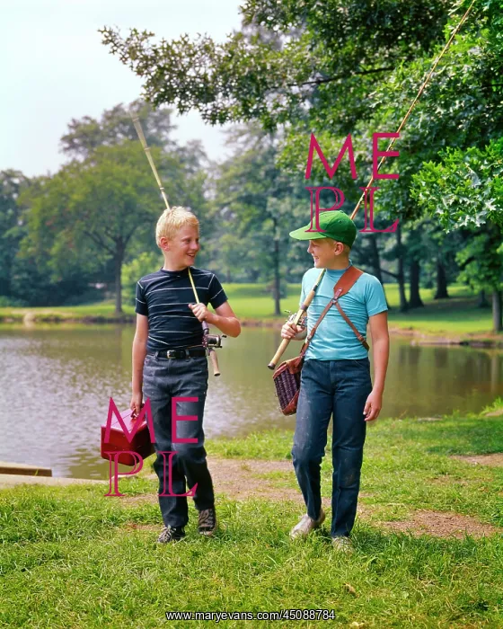 : Two Boys Walking Along Lakeside Talking Carrying : Two Boys Walking Along Lakeside Talking Carrying