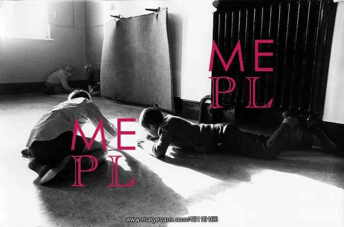: Boys work on the floor in an empty classroom : Boys work on the floor in an empty classroom