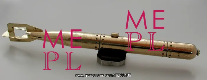 : Brass model of torpedo sitting on bakelite and metal stand : Brass model of torpedo sitting on bakelite and metal stand