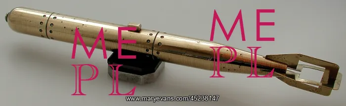 : Brass model of torpedo sitting on bakelite and metal stand : Brass model of torpedo sitting on bakelite and metal stand