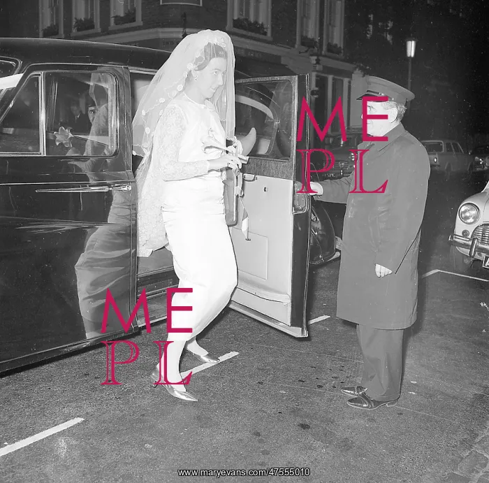 : A bride getting out of a wedding car : A bride getting out of a wedding car