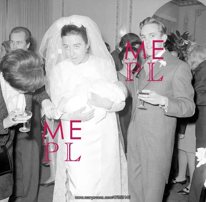 : A bride holding a baby at the reception : A bride holding a baby at the reception