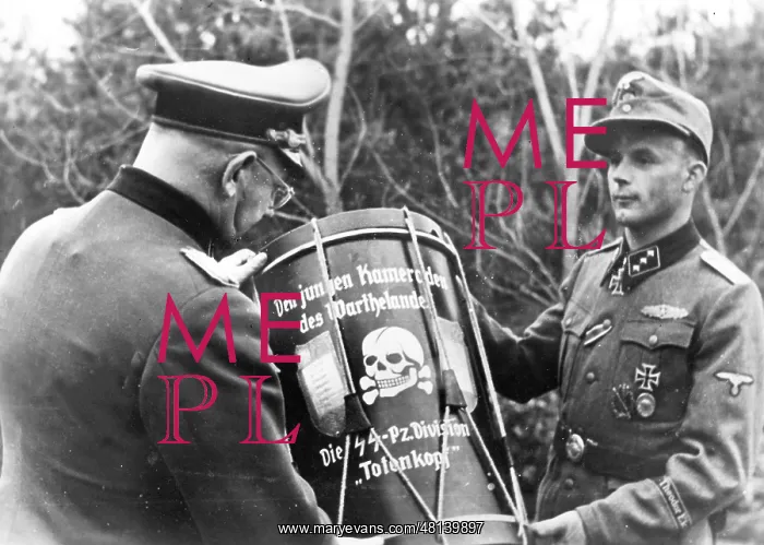 : Brigade Leader Helmut Bresser presents a drum : Brigade Leader Helmut Bresser presents a drum
