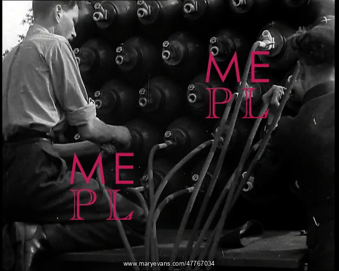 : Two British Men By a Large Stack of Gas Cannisters : Two British Men By a Large Stack of Gas Cannisters