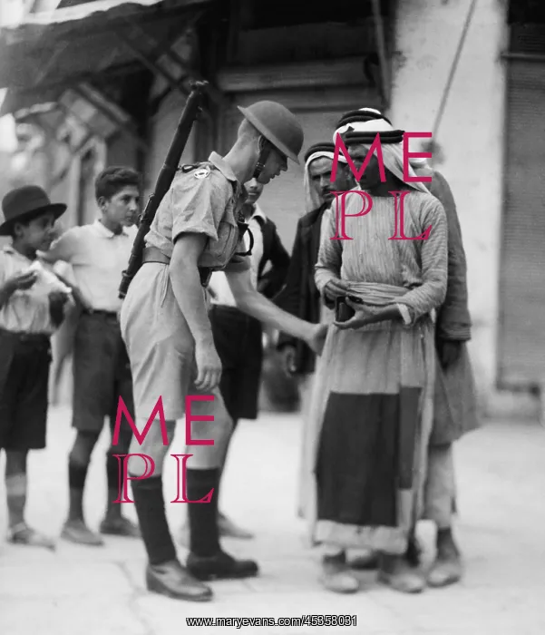 : British soldier checking papers and searching Arabs : British soldier checking papers and searching Arabs