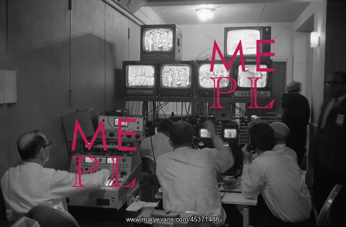: Broadcasting technicians, seated in front of bank : Broadcasting technicians, seated in front of bank
