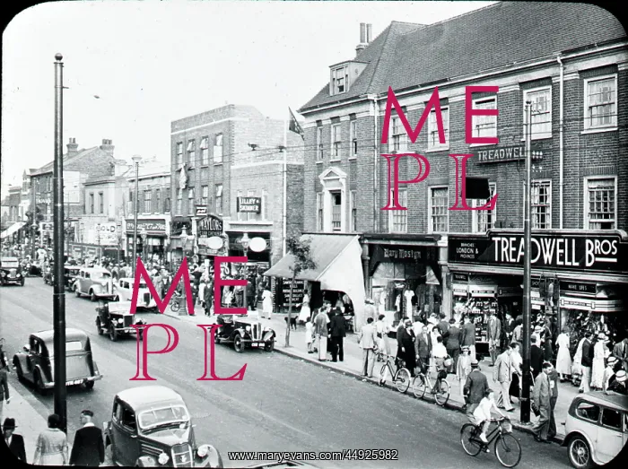 : Broadway. Broadway busy with shoppers and cars Lilley and Skinner and Taylors in shot : Broadway. Broadway busy with shoppers and cars Lilley and Skinner and Taylors in shot