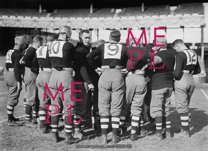 : Brown University football team in a huddle : Brown University football team in a huddle