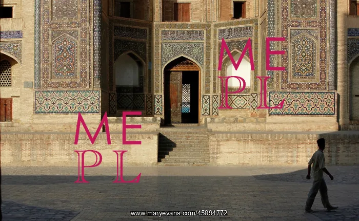 : Bukhara. Low angle view of man passing in front of the Mir-i-Arab Madrasah : Bukhara. Low angle view of man passing in front of the Mir-i-Arab Madrasah
