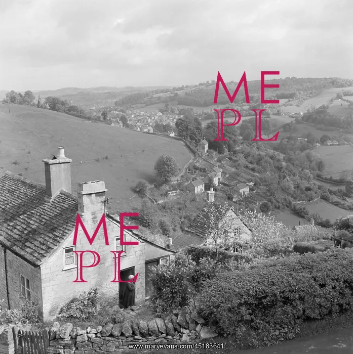  : Burleigh. An elderly lady walks out of her cottage on a hillside at Burleigh