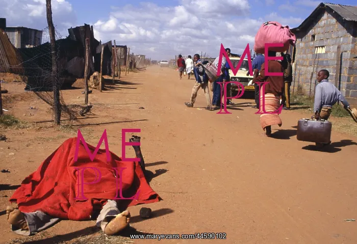 : The burned body of a man lies covered by a red : The burned body of a man lies covered by a red
