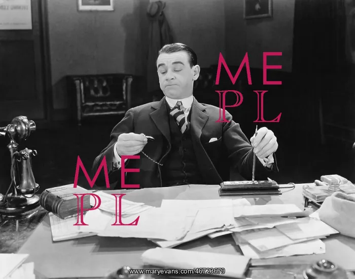 : Businessman at desk looking at watch : Businessman at desk looking at watch