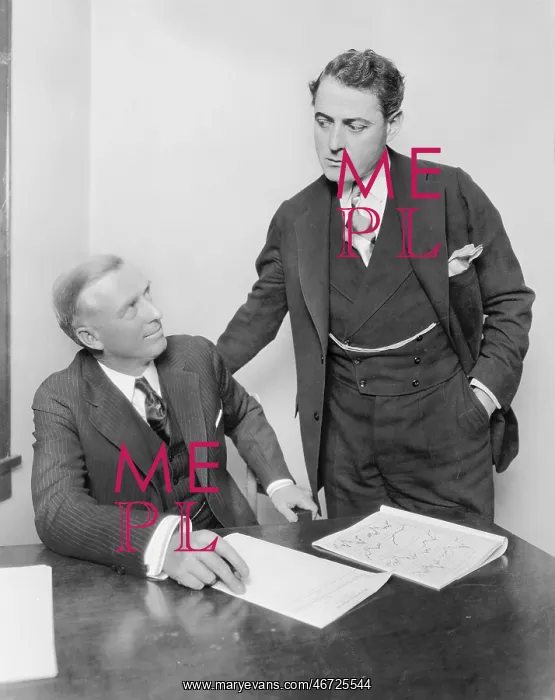 : Two businessmen in an office having a discussion : Two businessmen in an office having a discussion