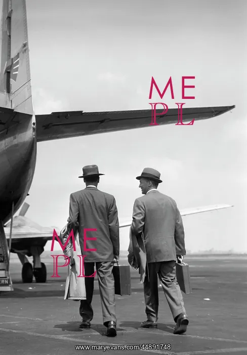 : Two businessmen walking towards a Martin 4-0-4 plane : Two businessmen walking towards a Martin 4-0-4 plane