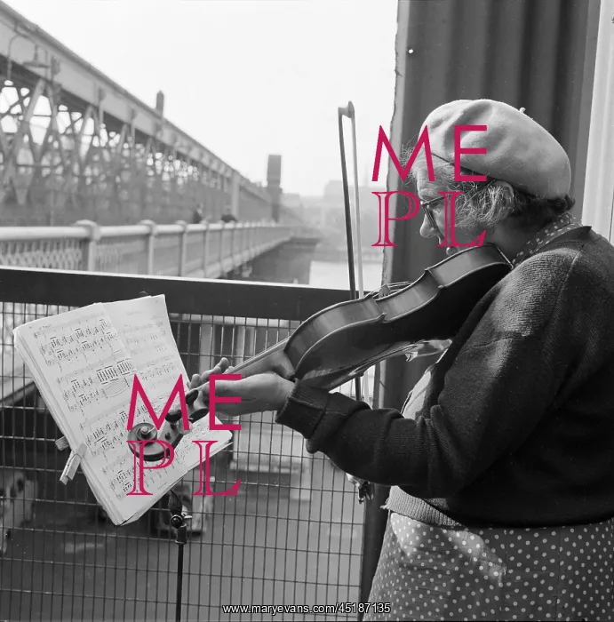  : Busker. An informal portrait of a woman busker playing the violin