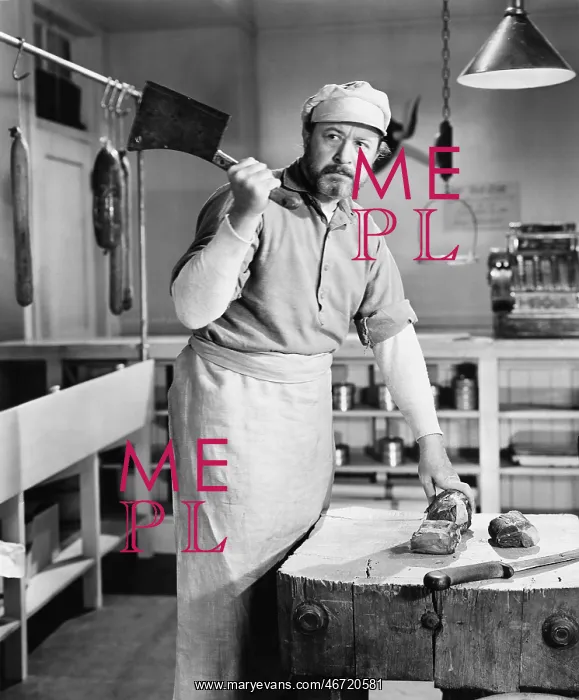 : Butcher chopping meat with cleaver : Butcher chopping meat with cleaver