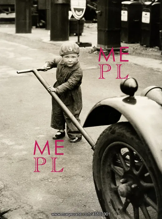: c.1920's - small child in overalls jacking up a car : c.1920's - small child in overalls jacking up a car