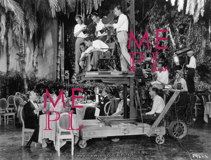 : A camera crane in use. Director Mervyn : A camera crane in use. Director Mervyn