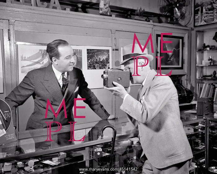 : Camera Store with Man Customer Looking Through : Camera Store with Man Customer Looking Through
