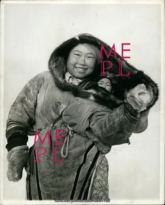 : Canada. Feb. 25 Canada: The Eskimo baby is carried in a parka-like hood : Canada. Feb. 25 Canada: The Eskimo baby is carried in a parka-like hood