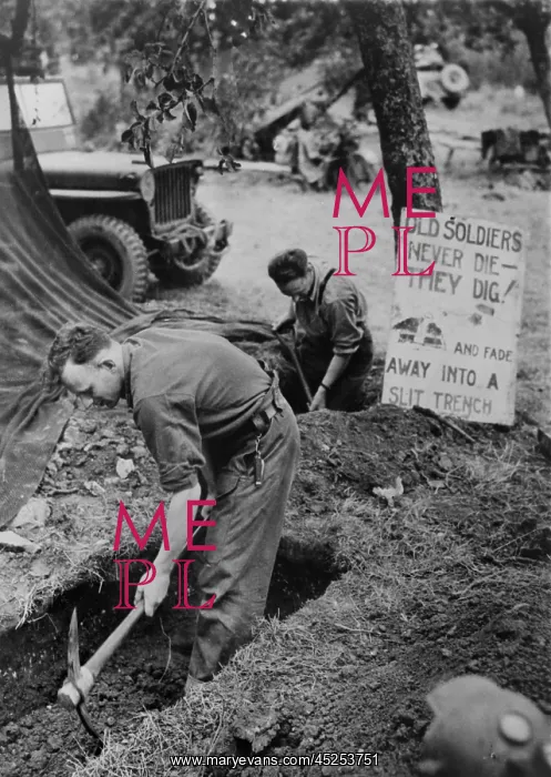 : Canadian troops in Normandy digging trenches outside : Canadian troops in Normandy digging trenches outside