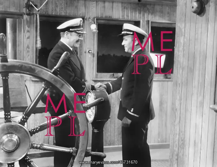 : Two captains shaking hands on a boat : Two captains shaking hands on a boat