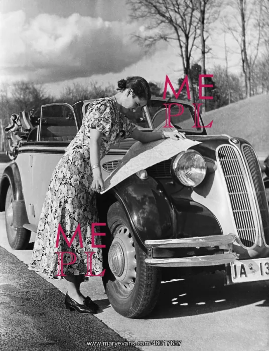 : Car driver with a road map, 1938 : Car driver with a road map, 1938