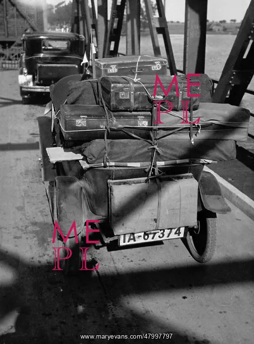: Car packed with suitcases on a bridge, 1931 : Car packed with suitcases on a bridge, 1931