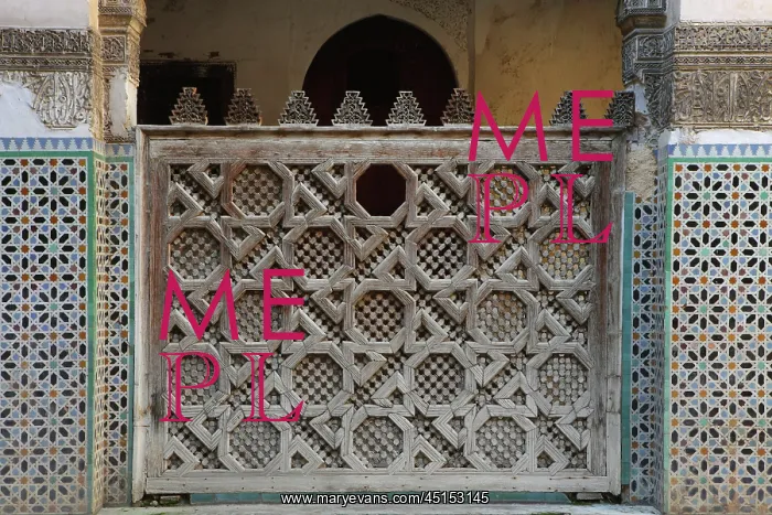 : Fez. Detail of carved wooden screen around central courtyard, Sahrij Medersa, : Fez. Detail of carved wooden screen around central courtyard, Sahrij Medersa,