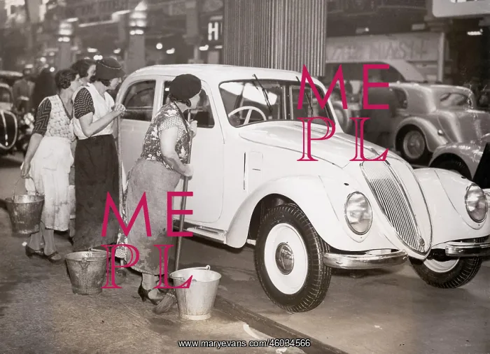 : Charladies examining a luxury limousine : Charladies examining a luxury limousine
