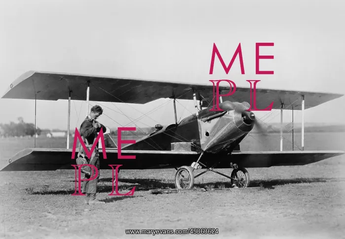 : Charles Lindbergh, adjusting parachute before testing : Charles Lindbergh, adjusting parachute before testing