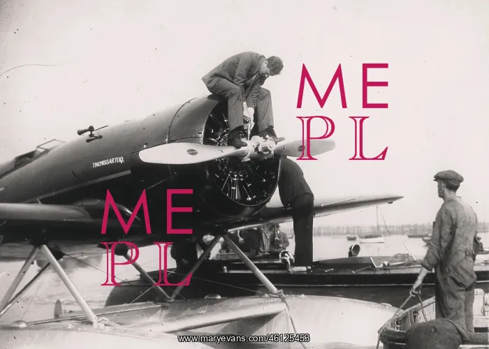 : Charles Lindbergh, American aviator, oiling propeller : Charles Lindbergh, American aviator, oiling propeller