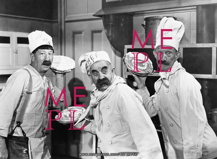 : Three chefs holding pies for a fight in the kitchen : Three chefs holding pies for a fight in the kitchen