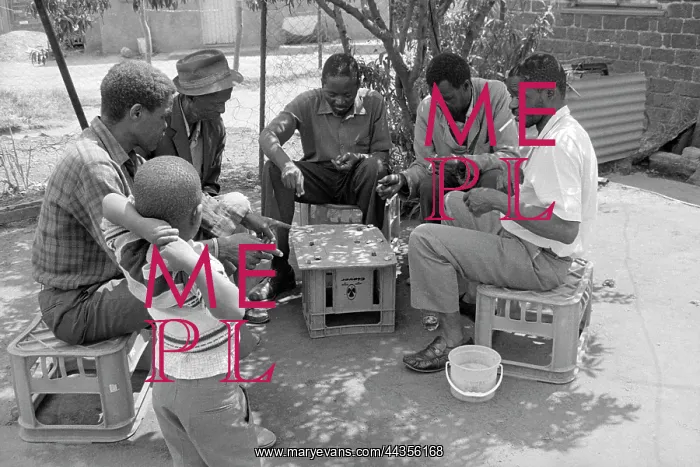 : Child watching shebeen players in Tembisa : Child watching shebeen players in Tembisa