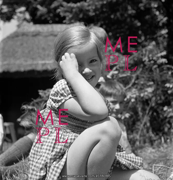  : Children. An informal portrait of a young girl in a smocked, gingham dress