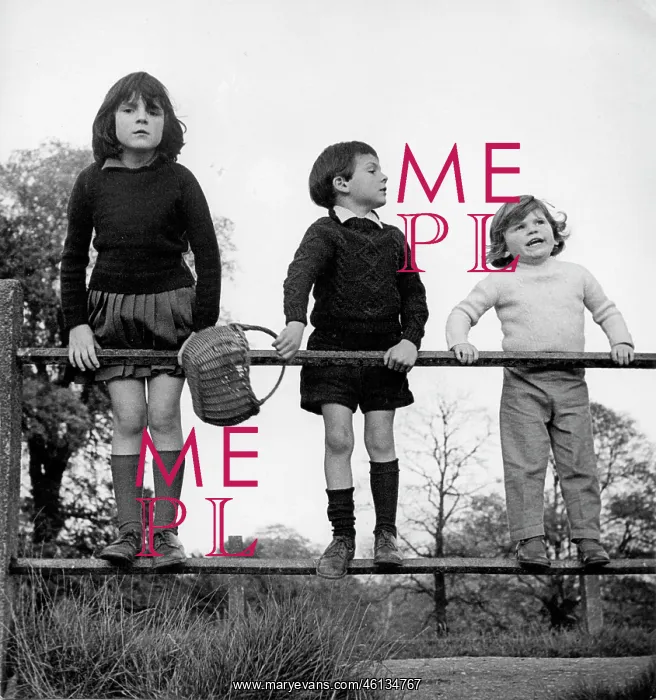 : Three children in age order standing on a railing : Three children in age order standing on a railing