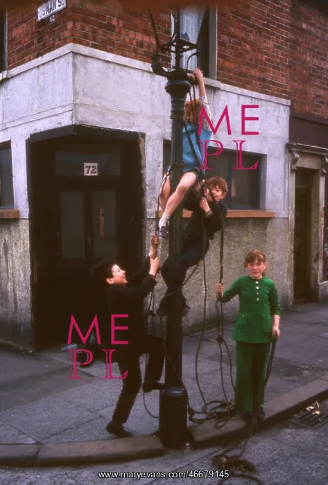 : Children attaching rope to lamp post, Northern Ireland : Children attaching rope to lamp post, Northern Ireland