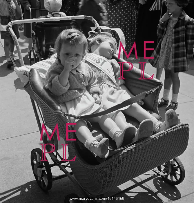 : Children in a baby stroller during a parade : Children in a baby stroller during a parade