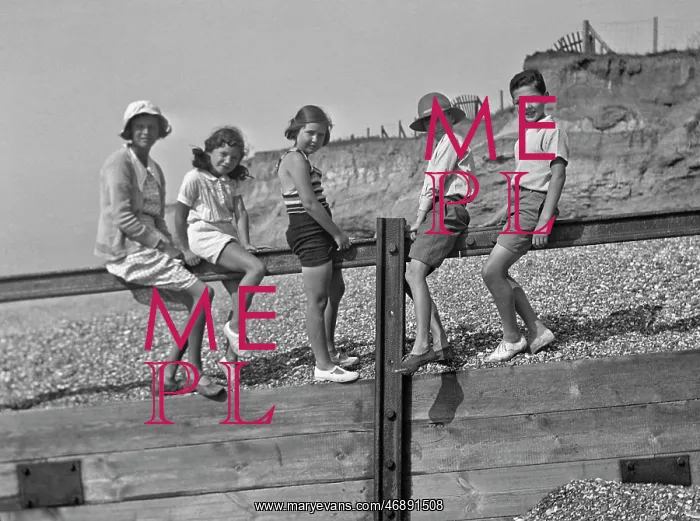: Five children on a breakwater at the seaside : Five children on a breakwater at the seaside